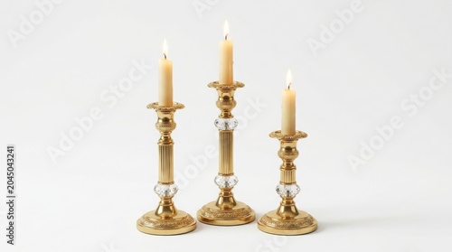 Vintage brass candlesticks with burning wax candles, elegant gold candle holders for home decor, antique metallic candelabra set with glowing flames isolated on White Background