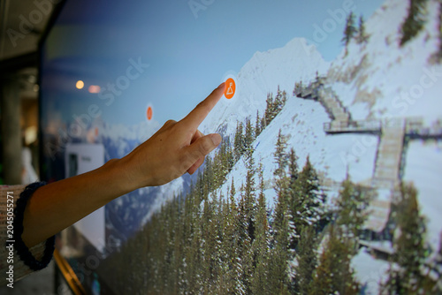 Billede på lærred Hand touching interactive map screen close up