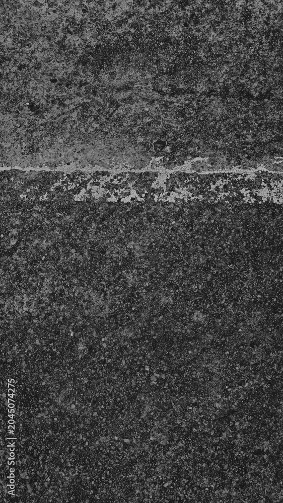 Fototapeta premium Dark, textured concrete mobile wallpaper with a rough, gritty surface and subtle white line