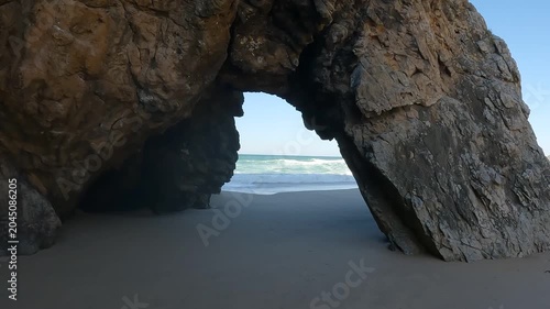 POV Walk Towards Iconic Sea Arch at Praia da Adraga on the Atlantic Coast, Sintra, Portugal