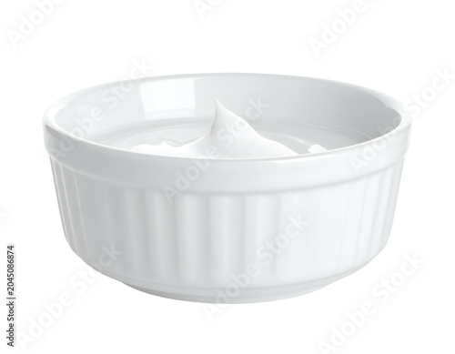 A white ramekin holds a creamy swirl of rich, thick dairy product