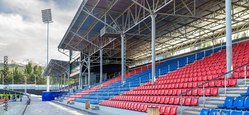 Billede på lærred High Altitude Stadium With Empty Grandstand And Mountain Landscape Background
