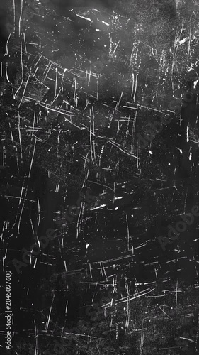 Abstract dark metal surface with deep scratches and weathered texture.