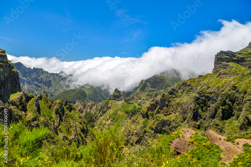 Clouds rolling over rugged volcanic peaks