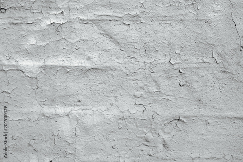 Photos Light gray distressed surface with peeling paint on a brick wall backdrop, textu