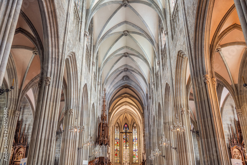 Gothic church nave with vaulted ceiling and stained glass