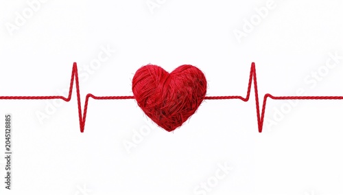 Red yarn heart with heartbeat cardiogram line on white background, medical healthcare concept asset