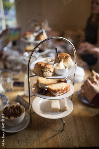 Obraz na płótnie Traditional British afternoon tea stand with scones cream and sandwiches indoors