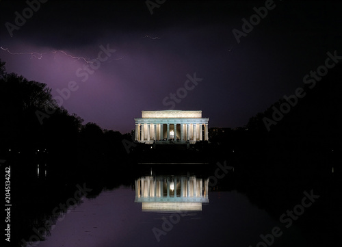 Lincoln memorial at night with summer storm, purple lightning above and behind, Reflecting Pool