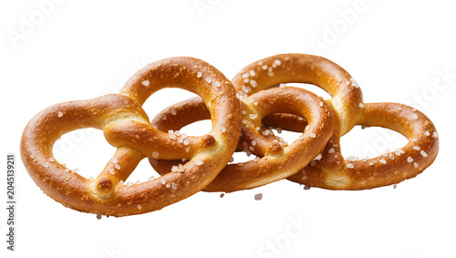 Quadro su tela Isolated tasty trio of freshly baked golden brown German pretzels with salt crystals