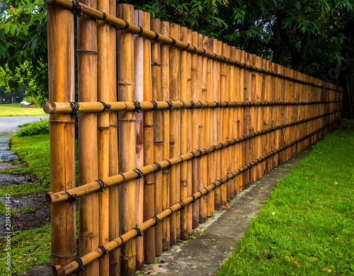 Long Rustic Bamboo Fence Extending Through Lush Green Garden Path