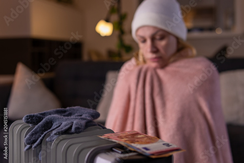 Konstfotografi Woman feeling cold at home, struggling with rising heating costs, high utility b