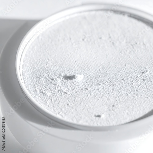 Fine White Powder Resting in Round Laboratory Dish on White Surface