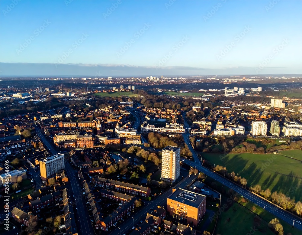 Fototapeta premium Sunny Aerial View of Urban Neighborhood and Green Parkland at City Edge