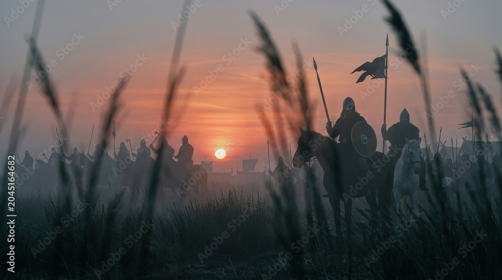 Fototapeta premium Silhouetted Viking warriors on horseback at sunset crossing a reed-filled landscape, depicting an epic historical scene of Norse riders preparing for battle. Dramatic medieval adventure.