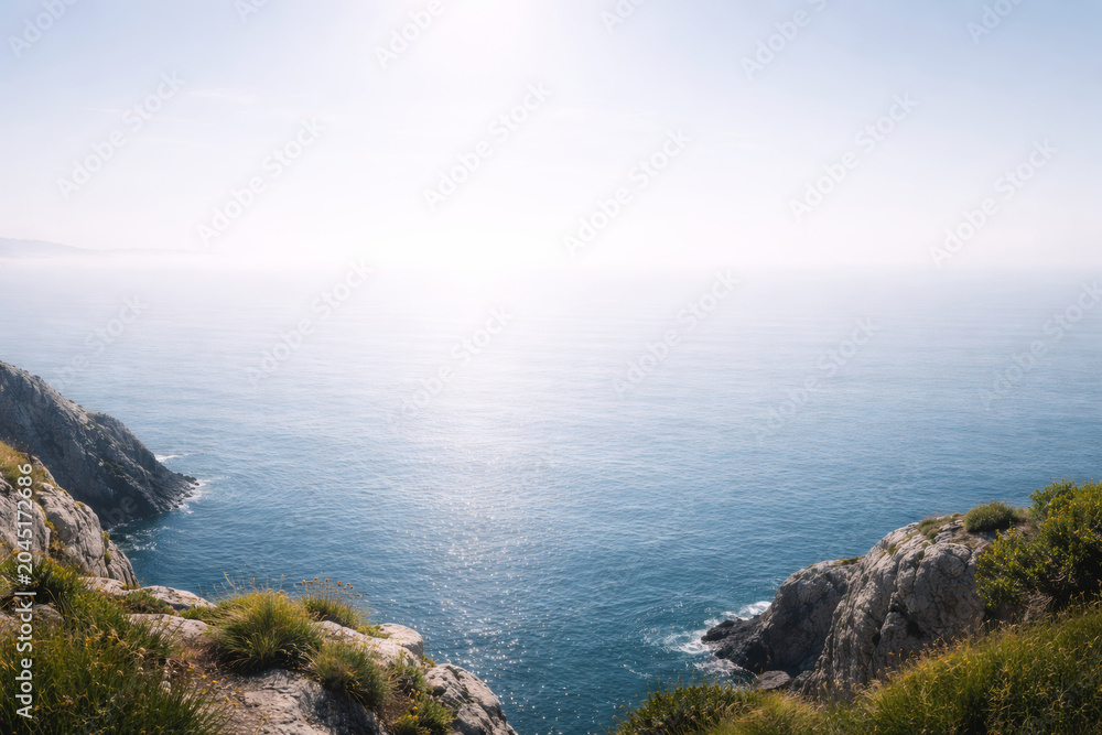 Fototapeta premium Serene coastal view overlooking calm ocean waters and rocky cliffs