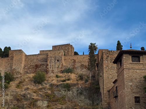 Alcazaba of Malaga Fortress Walls and Tower under Blue Sky in Andalusia Spain