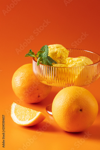 Vertical close up of orange ice cream with fresh fruits
