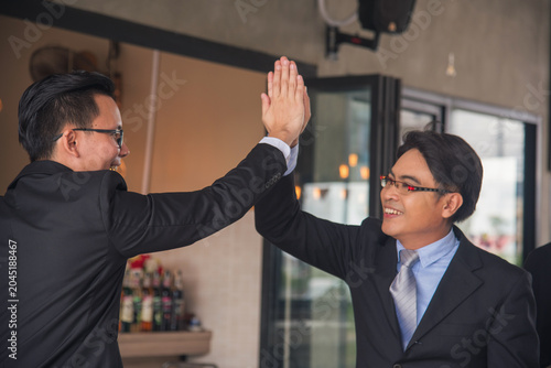 Teamwork high five as team together hands raise up greeting power tag teams. Diversity multiethnic two people success unity togetherness in Volunteer community. Collaborate Business partner win teams