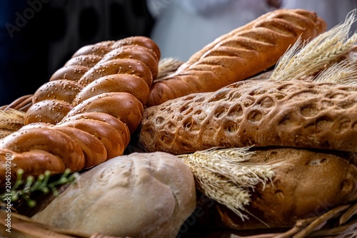 Artisanal Bread Basket with Assorted Loaves and Wheat