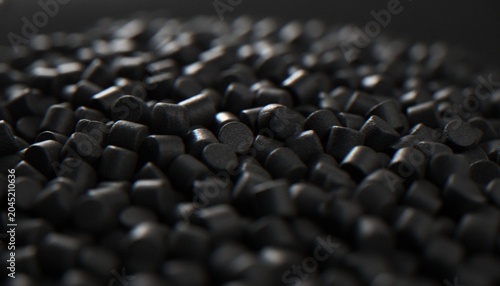 Photography A close-up, macro shot of black plastic resin pellets or granules used in the industrial manufacturing process