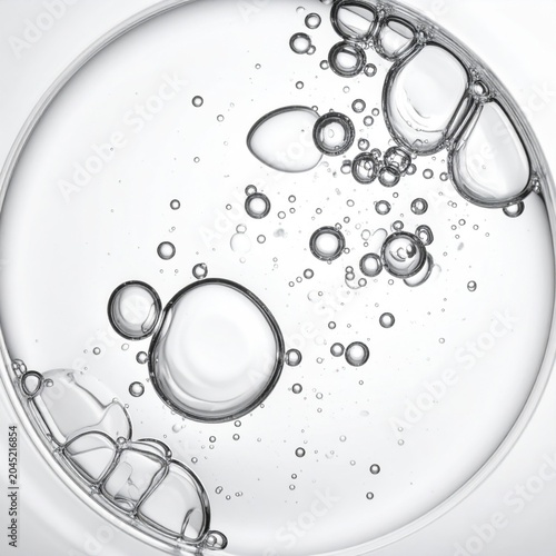Macro closeup of clear liquid bubbles in circular frame, scientific laboratory sample, transparent fluid texture, perfect for skincare and chemistry backgrounds