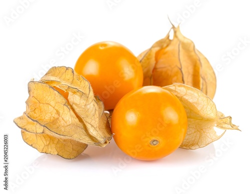 Ripe cape gooseberries in papery husks on natural burlap, close-up white background