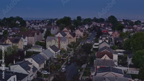 Dusk aerial footage showing Northern New Jersey suburbs with Met Life stadium and NYC skyline on the horizon. Town of East Rutherford NJ, USA.