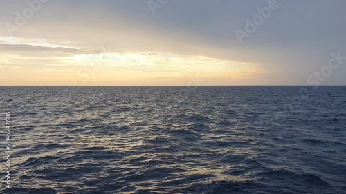 various shapes of clouds in the sky above the choppy sea