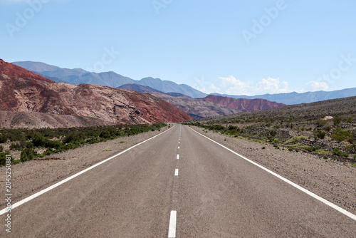 Endless Desert Highway Through Arid Mountain Landscape
