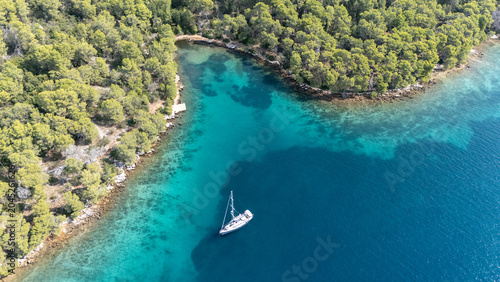 Obraz na plátně Sailboat anchoring in paklina cove, hvar island, croatia