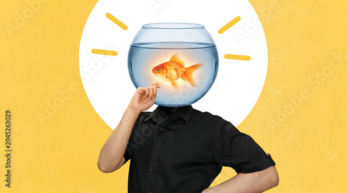 Creative person with fishbowl mask holding golden koi fish under lightbulb symbolizing innovation and inspiration