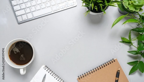 Modern white office desk workspace with keyboard and coffee