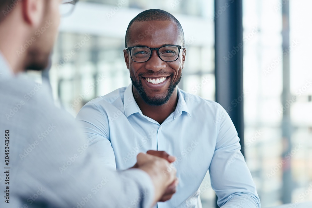 Obraz premium Smiling man handshake during business meeting in office