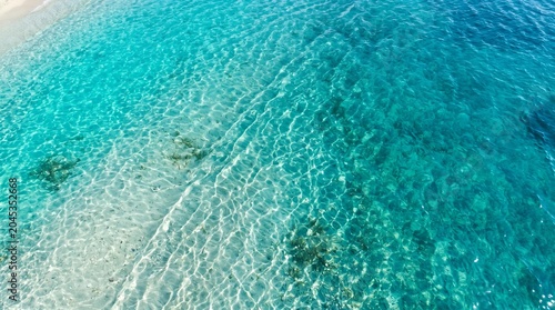 Clear Blue Ocean Water with Sunlight Reflections