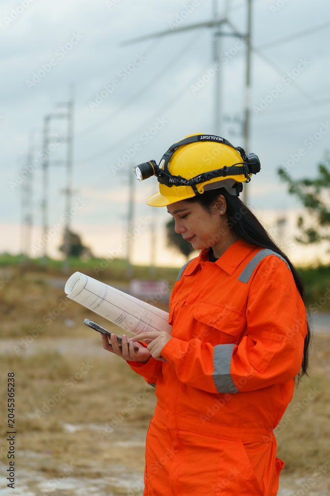 Obraz premium Technicians are using surveying equipment to inspect the integrity of the road construction at the wind turbine farm.
