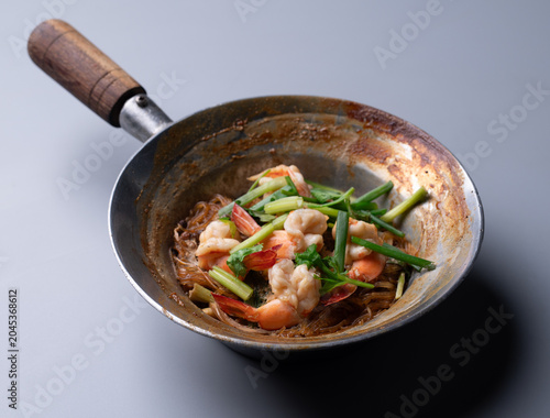 Baked prawns with glass noodles and herbs in traditional pot