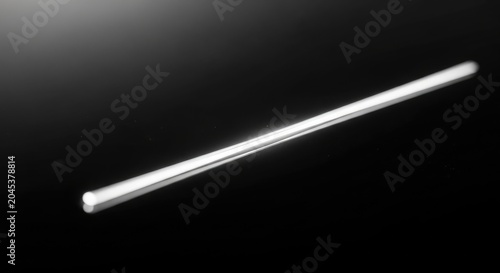 Sleek Silver Rod Isolated on Black Background with Dramatic Lighting.