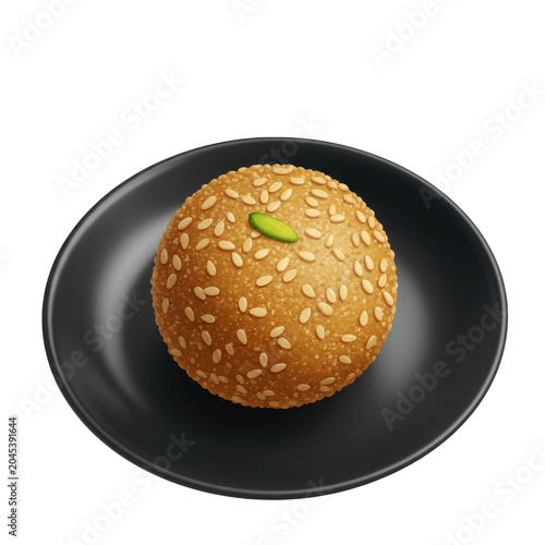 Sesame seed laddu with pistachio on a black plate top view isolated on white background