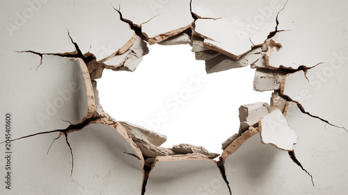 Broken white wall with a large hole and exposed concrete and plaster fragments