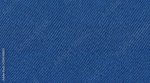 Close-up view of a textured royal blue denim fabric, showcasing its woven pattern and deep color