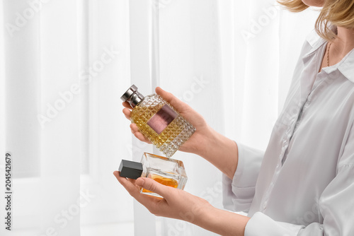 Young woman with bottles of...