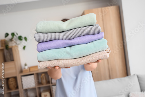 Woman holding stack of diff...