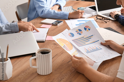 Business team working with graphics during meeting in office, closeup