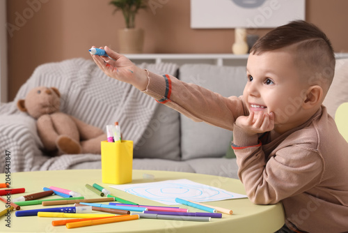 Funny little boy drawing wi...
