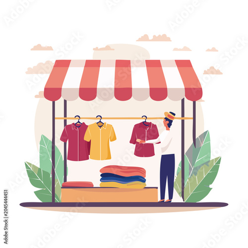 Man at a clothing stall with shirts and folded clothes