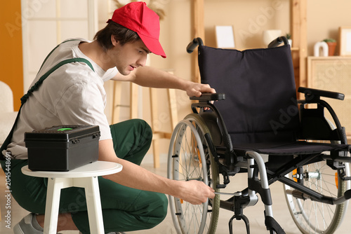 Young worker repairing whee...