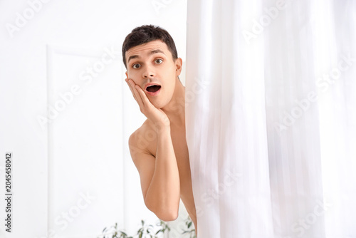 Shocked young man behind cu...