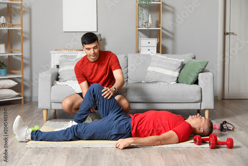 Mature man training on mat ...