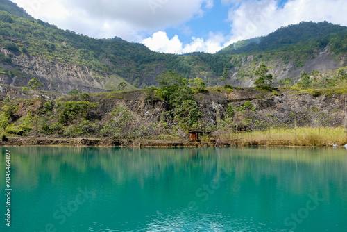 Panguna mine town pit lake with turquoise water and pumping station in Autonomous Region of Bougainville, Papua New Guinea